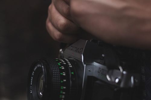 person holding black DSLR camera