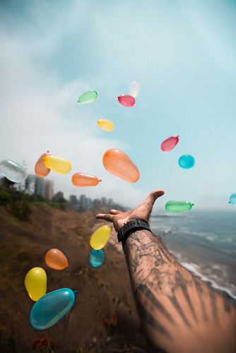 person throwing balloons