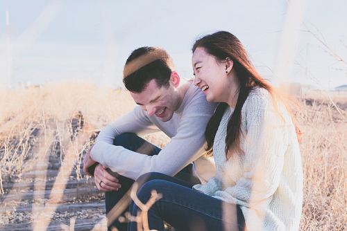 photo of man and woman laughing during daytime