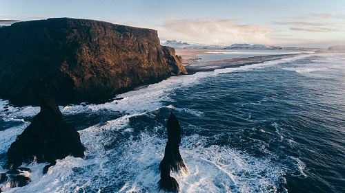 photo of rock formations on body of water