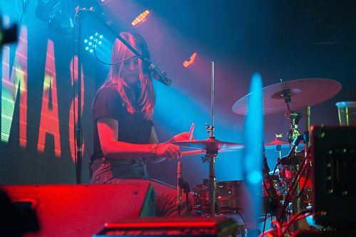 photo of woman playing drums