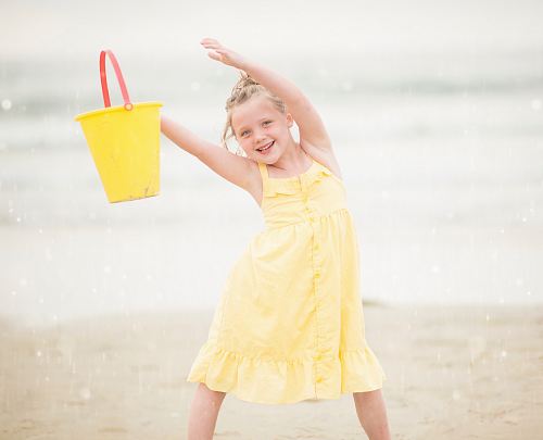 selective focus photography of girl standing near sea shore
