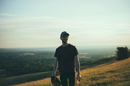selective photography of man standing on grass field