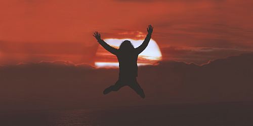 silhouette of person doing jumpshot during sunset