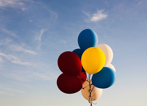 white, yellow, red, and blue balloons under blue sky