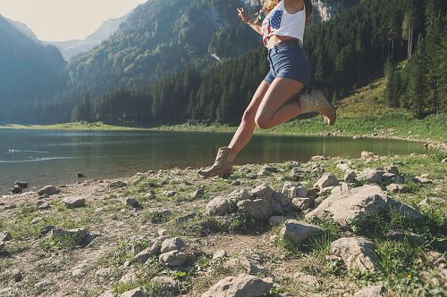 woman jumping near river