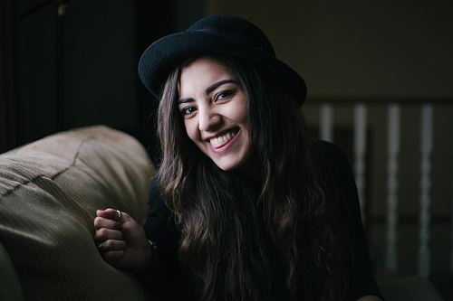 woman smiling while sitting on couch