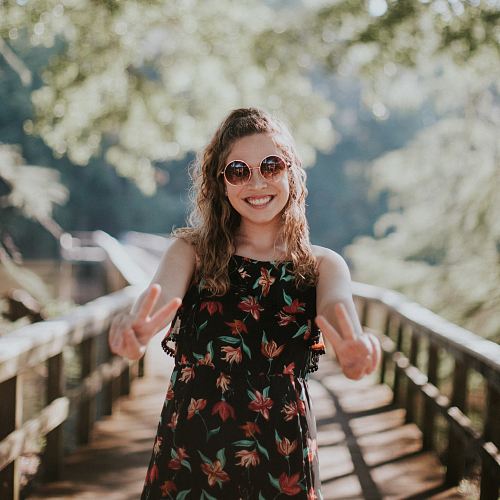 woman standing on wooden bridge