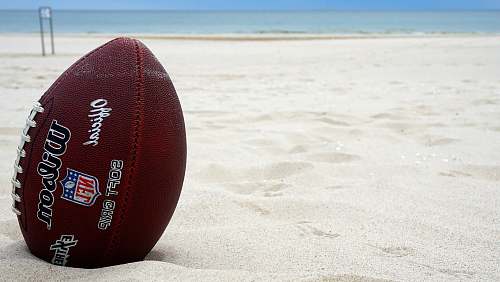 sports brown Wilson football on sand sport