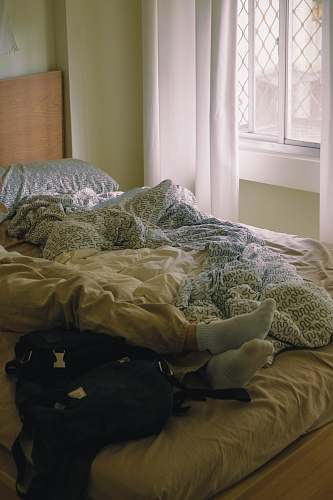 bedroom black backpack on bed indoors