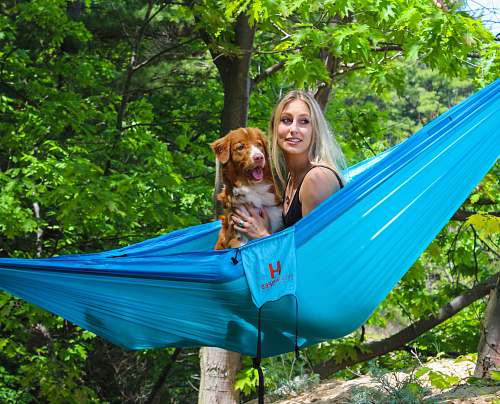 hammock woman and dog on blue hammock flora