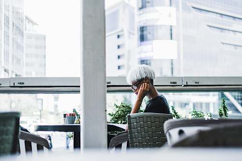 person man sitting on chair in front of table sitting