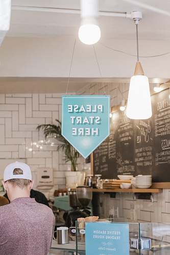 person man standing near display counter \ restaurant