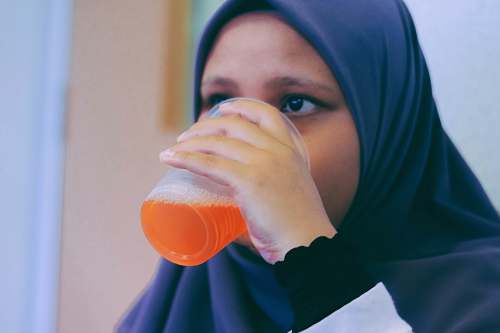 person woman in black hijab headdress white drinking people