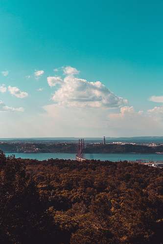 weather brown islet and body of water sky