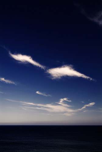 outdoors ocean below white clouds sky
