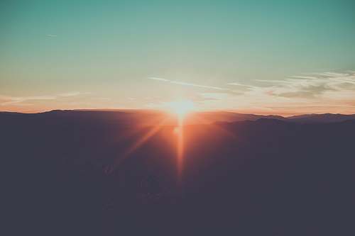 sun silhouette photography of mountain light
