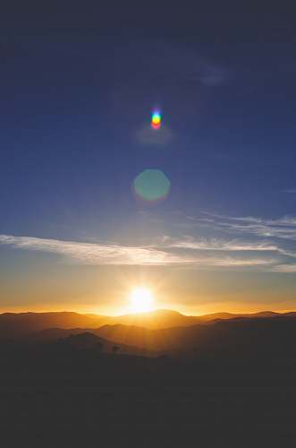 sun silhouette of mountain during sunset outdoors
