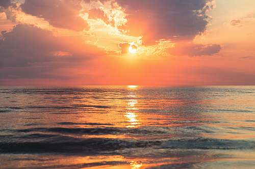 ocean sea under white clouds at golden hour nature