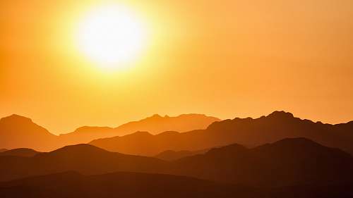 sunrise silhouette of mountains under orange sky sky