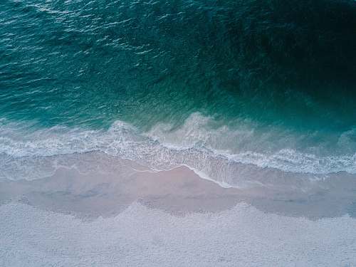 ocean body of water beside sand sea