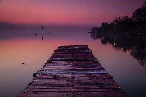 waterfront wooden dock during golden hour pier