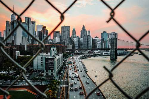 urban gray concrete building near body of water under gray and white sky wallpaper