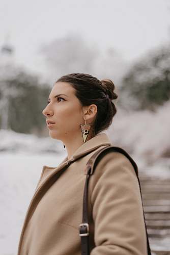  selective focus photography of woman in brown coat 