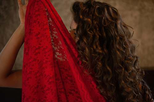 clothing woman covering her face with red textile human