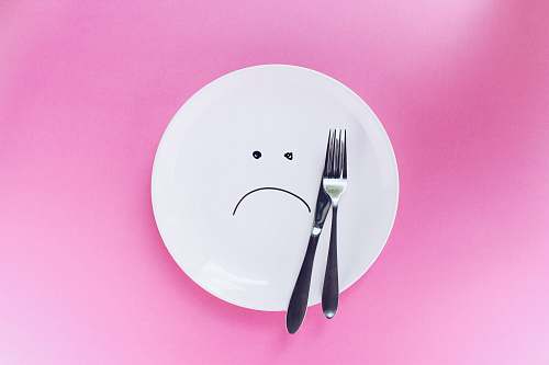 plate silver fork and knife on plate pink