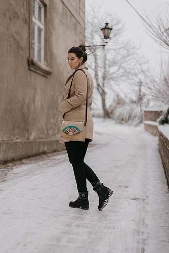 apparel woman standing beside concrete house clothing
