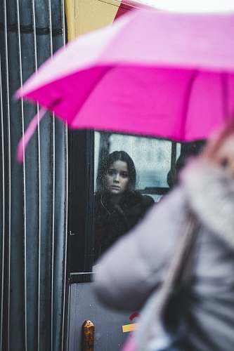 umbrella woman standing inside glass window canopy