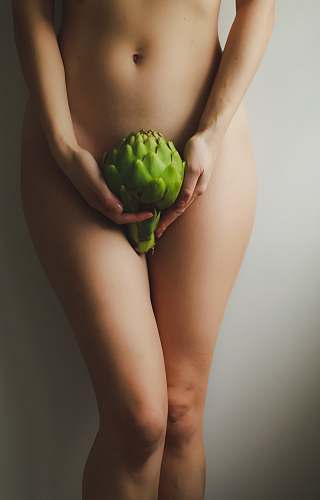 food naked woman holding green fruit produce