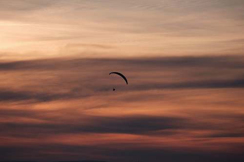 paragliding person gliding parachute in sky paraglider