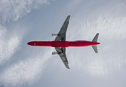transportation red and white passenger airplane on the sky during daytime aircraft