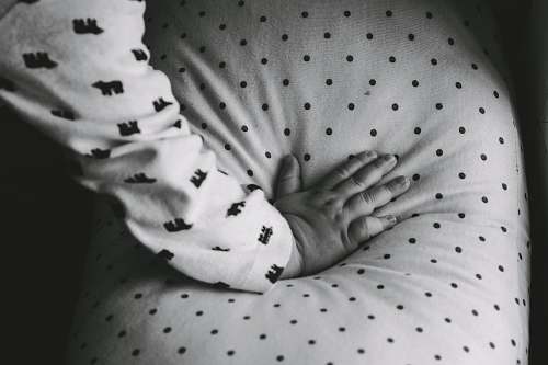 newborn grayscale photography of baby's hand black-and-white