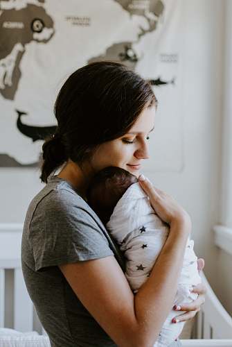 newborn mother carrying baby mother
