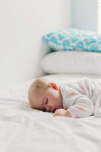 newborn photo of baby laying on bed kid