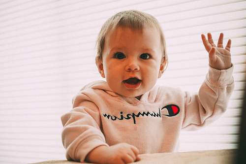 person smiling toddler wearing white Champion pullover hoodie human