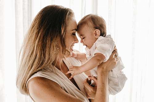 human smiling woman carrying baby person