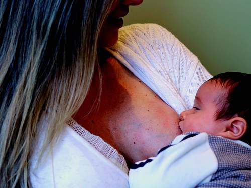newborn woman breastfeeding person