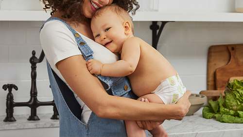 newborn woman carrying baby diaper