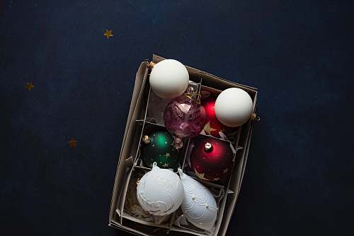 ornament shallow focus photography of six assorted-color baubles bowl