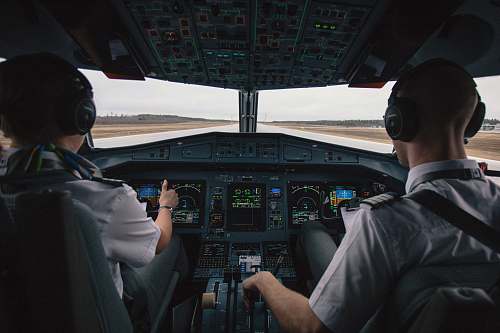 people two men driving plane at daytime human