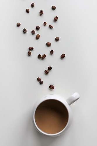 cup coffee beans and coffee filled mug coffee cup