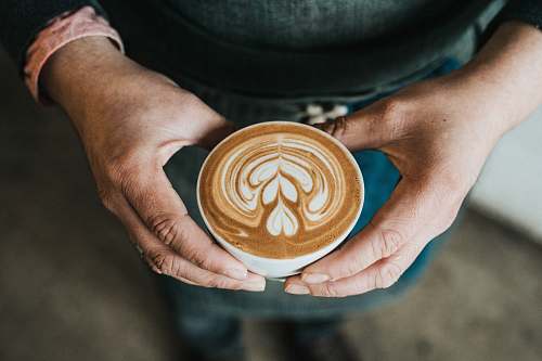 human focus photography of coffee artwork person