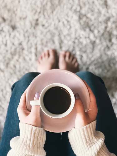 person person holding cup of coffee human