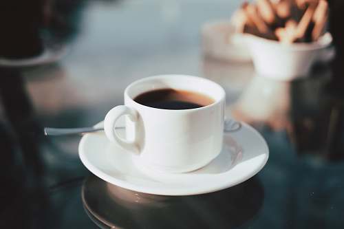 coffee cup of coffee on white ceramic saucer coffee cup