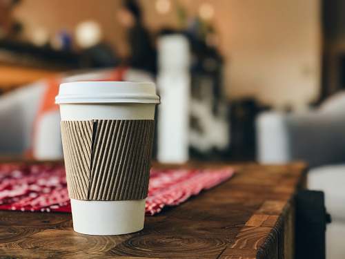 coffee white plastic cup on brown surface disposable
