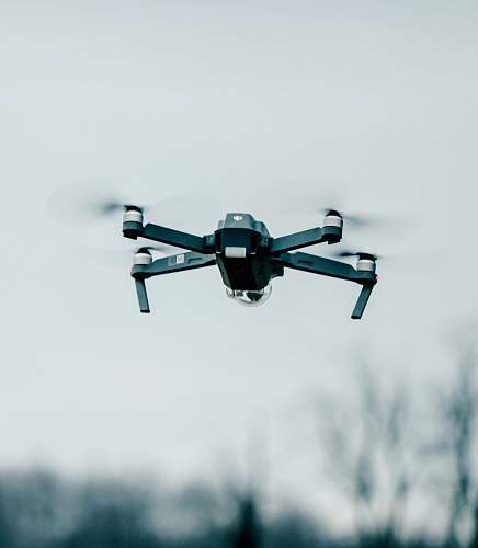 fly selective focus photography of flying quadcopter equipment